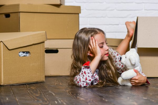 extraordinary location cardboard boxes moving to new house purchase of new habitation happy child cardboard box moving concept new apartment happy little girl with toy